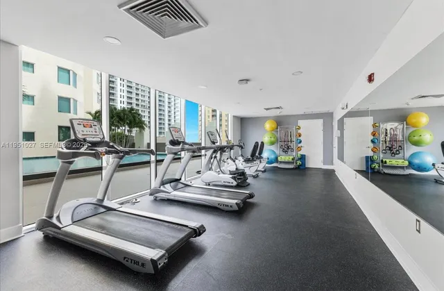 a vase with flowers sitting on a table with potted plants