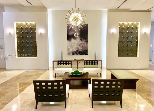 a roof deck with couches and a potted plant on a table