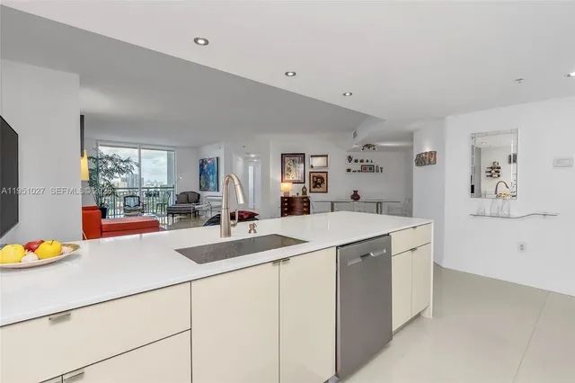 a view of a refrigerator in kitchen and a sink