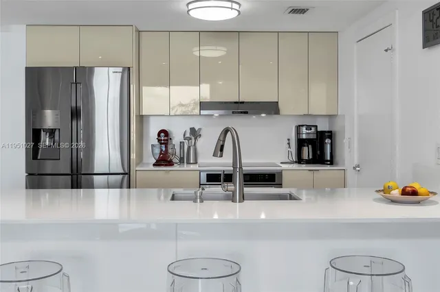 a living room with furniture and paintings on the wall
