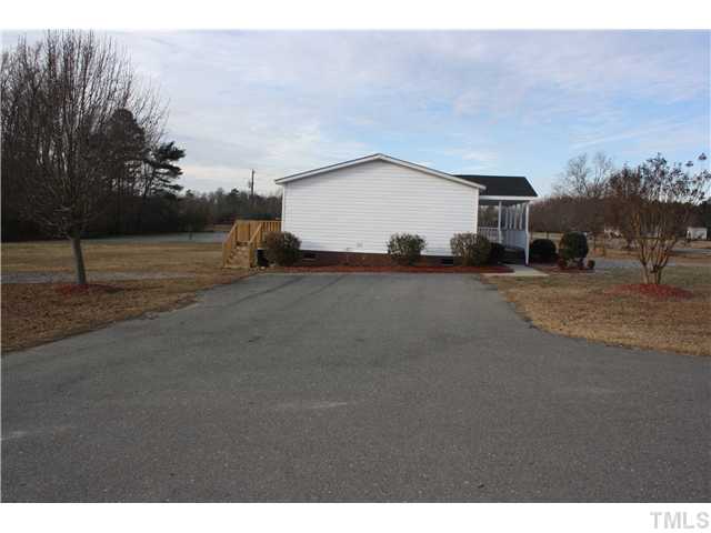 799 Bakers Chapel Road Princeton, NC 27569 - Photo 8 of 14 SIDE VIEW WITH DECK IN BACK AND PAVED DRIVEWAY