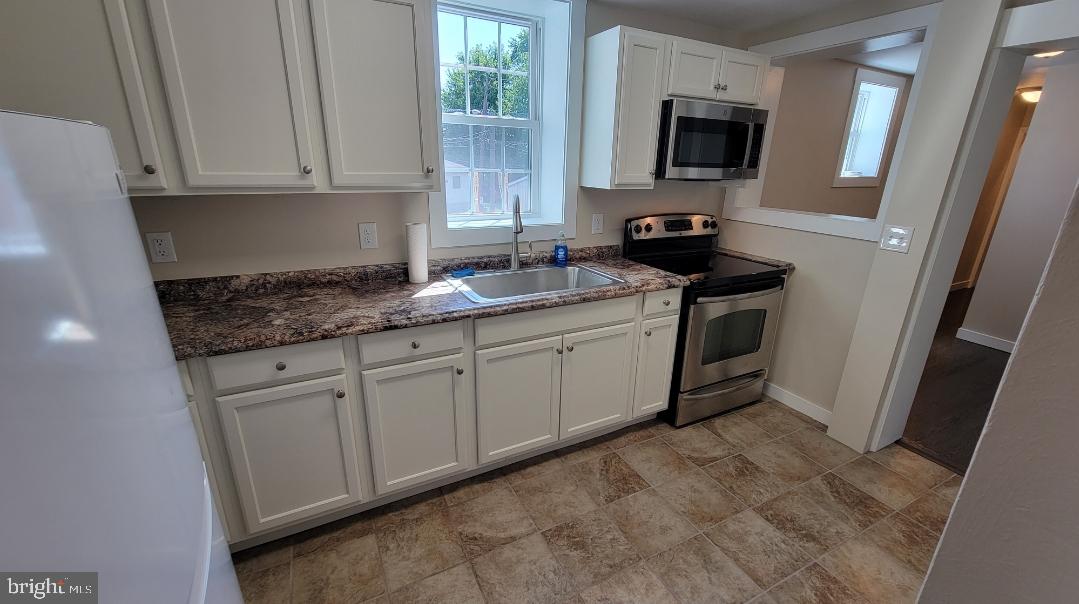222 State Street Enola, PA 17025 - Photo 27 of 42 a kitchen with stainless steel appliances granite countertop a sink stove and microwave