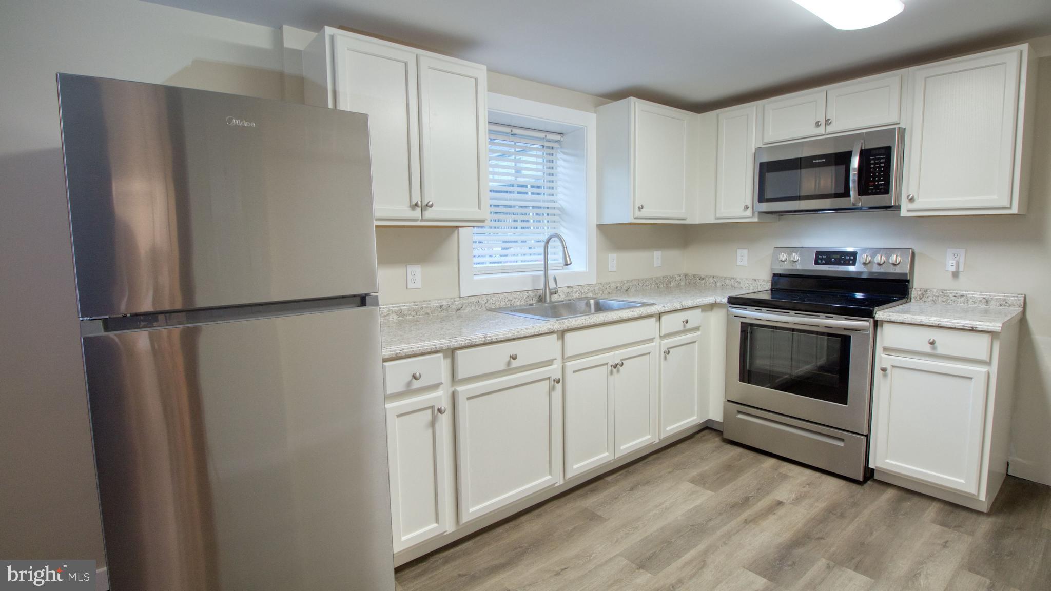 222 State Street Enola, PA 17025 - Photo 28 of 42 a kitchen with white cabinets stainless steel appliances and sink