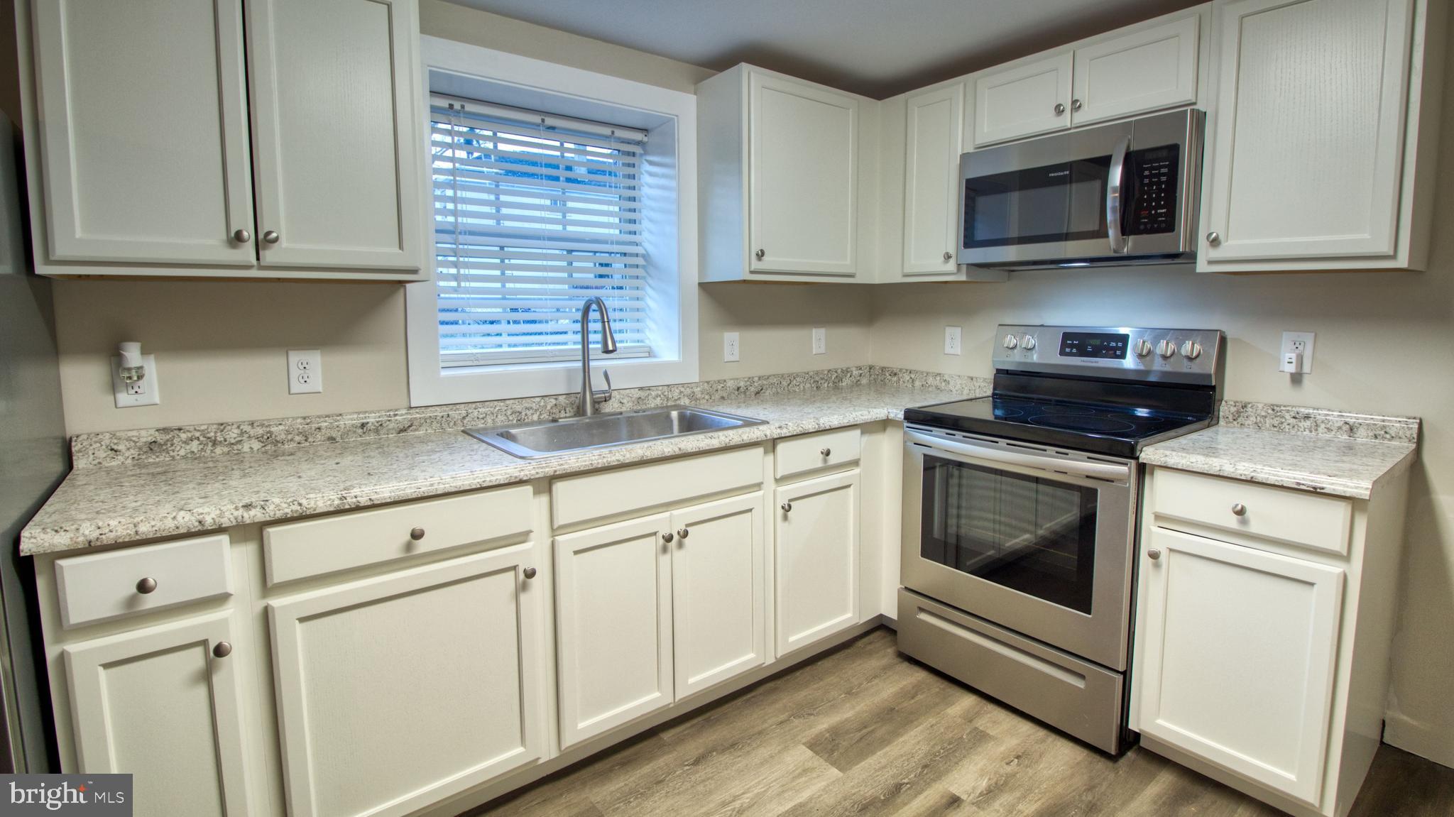 222 State Street Enola, PA 17025 - Photo 29 of 42 a kitchen with granite countertop cabinets stainless steel appliances and a sink
