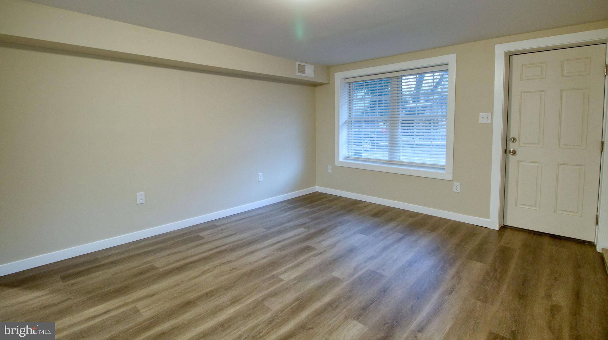 222 State Street Enola, PA 17025 - Photo 33 of 42 a view of an empty room with wooden floor and a window