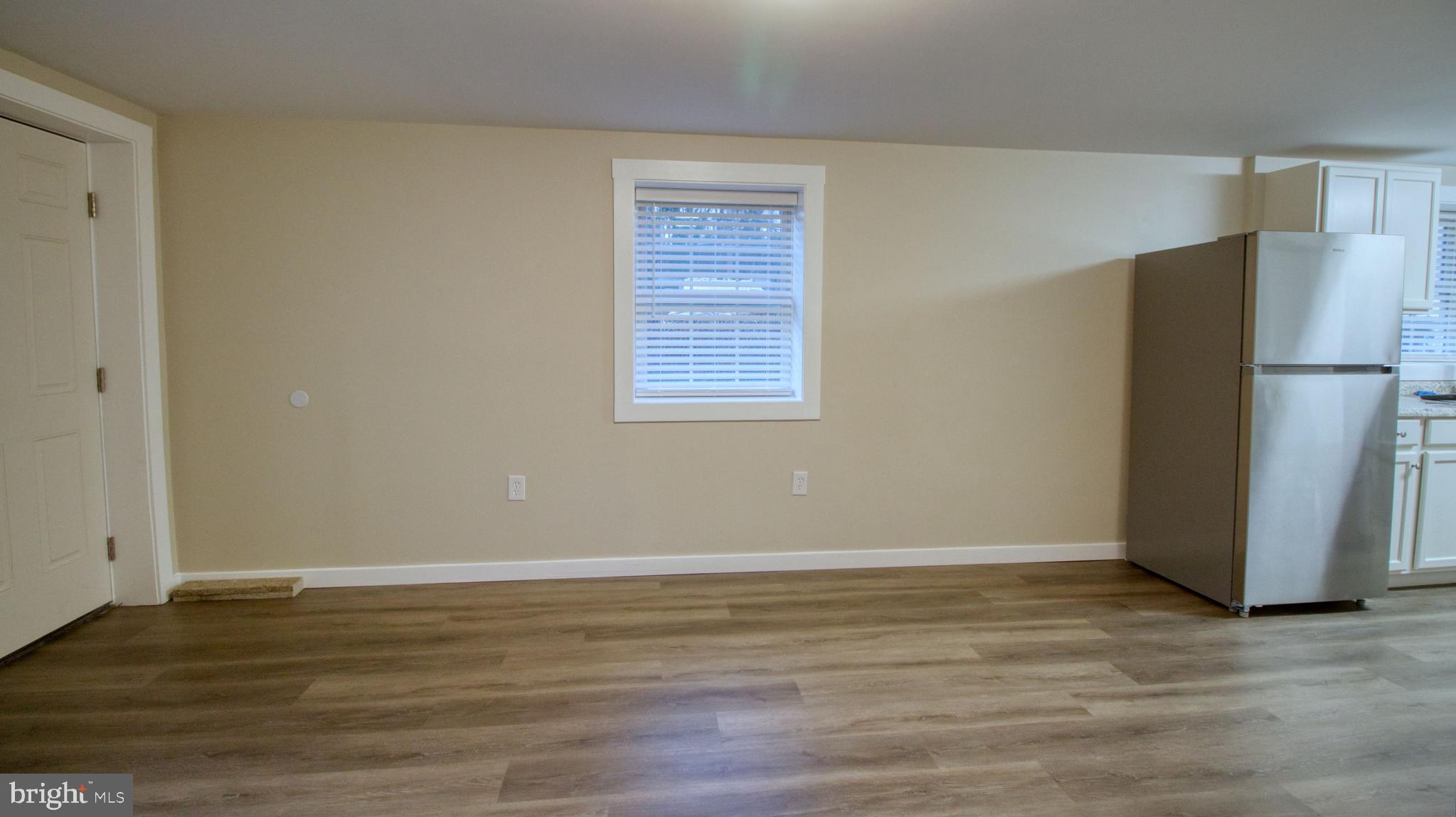 222 State Street Enola, PA 17025 - Photo 35 of 42 a view of an empty room with wooden floor and a window