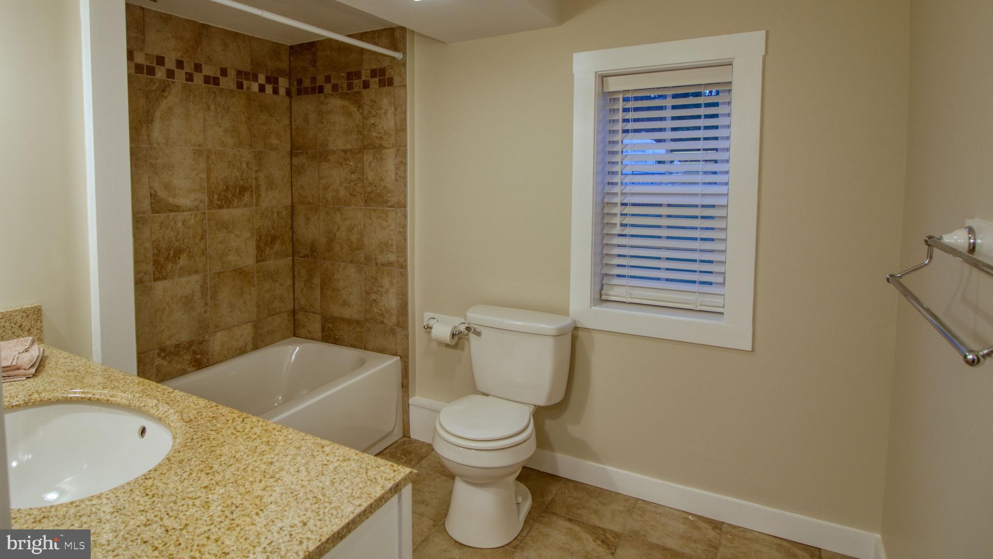 222 State Street Enola, PA 17025 - Photo 38 of 42 a bathroom with a granite countertop toilet a sink and bathtub