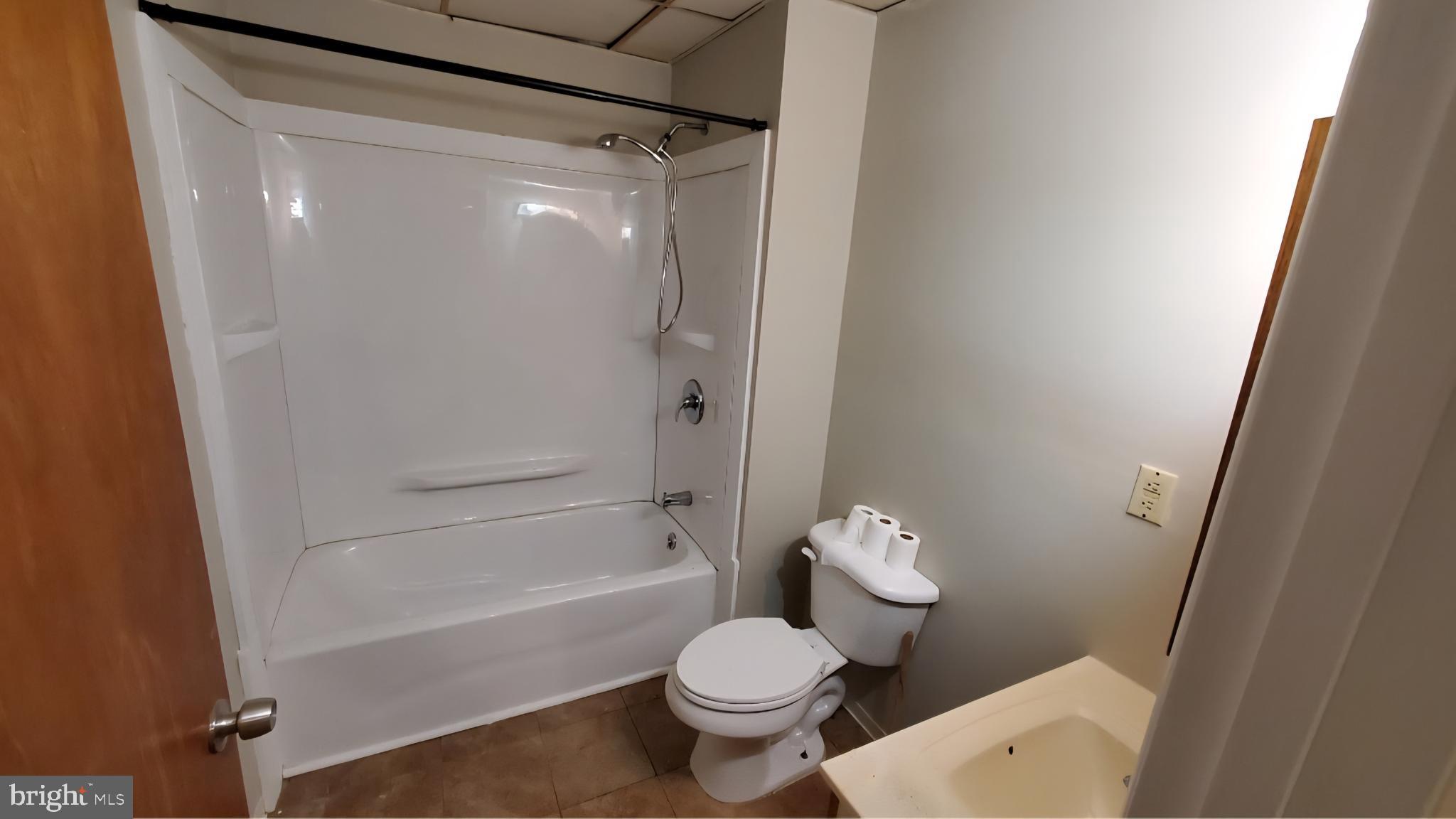 222 State Street Enola, PA 17025 - Photo 9 of 42 a white toilet sitting next to a bath tub