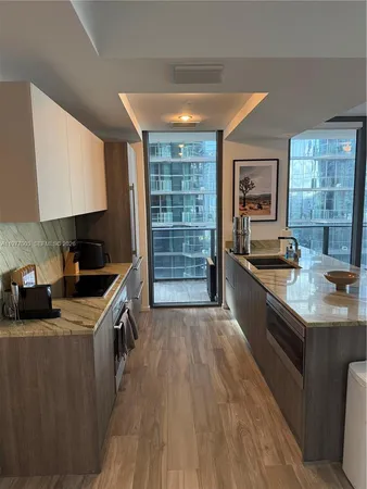a kitchen with kitchen island a sink a stove and a refrigerator