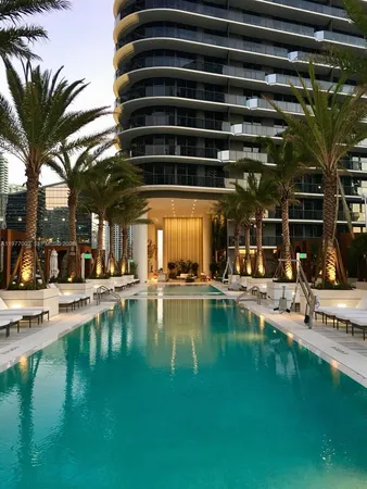 a view of a swimming pool with outdoor seating