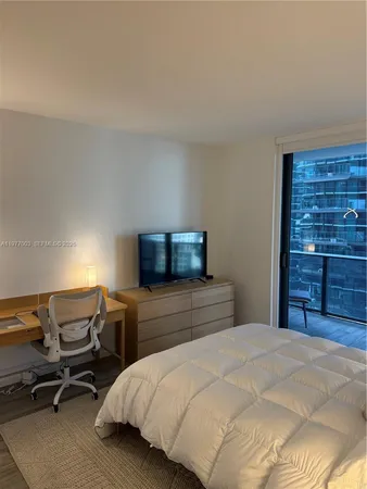 a bedroom with a bed and a wall painting