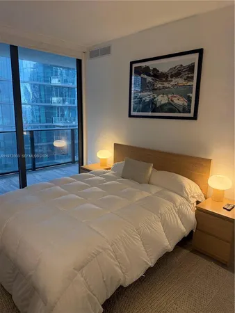 a room with a bed and a flat screen tv