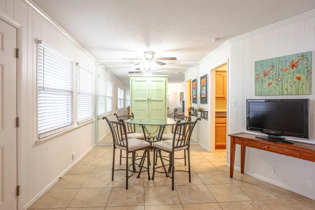 a view of a dining room with furniture and a flat screen tv