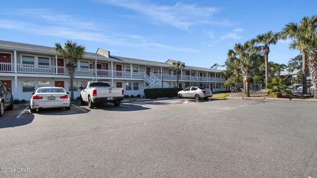 a front view of a house with yard and trees