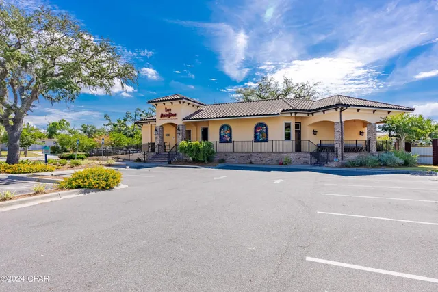 a view of a building with a tub and trees in the background