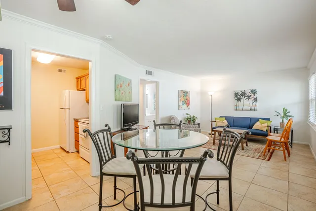 a dining room with furniture and wooden floor