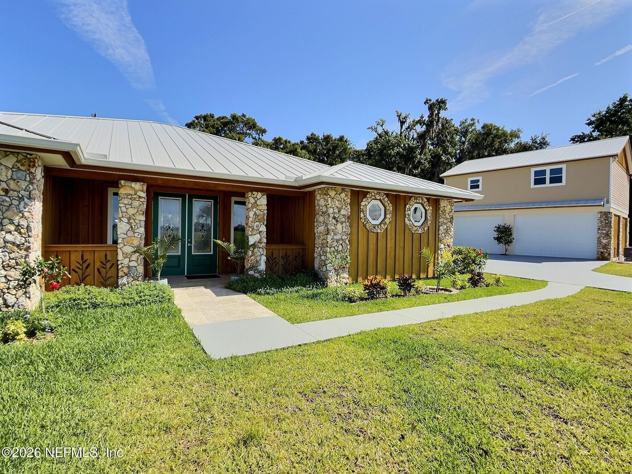 159 Mays Cove Road East Palatka, FL 32131 - Photo 5 of 62 a front view of a house with a yard and garage