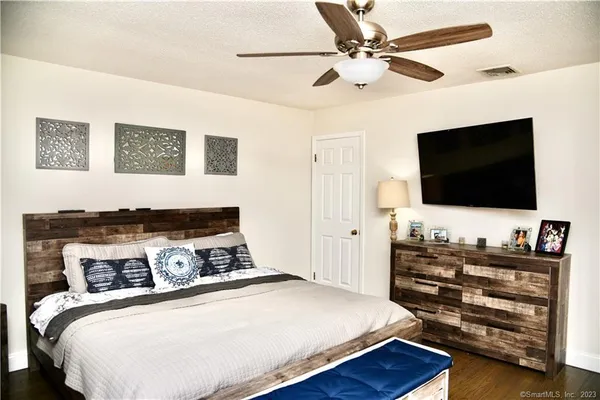 a bedroom with a bed and a flat screen tv