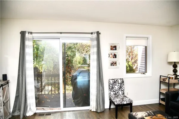 a view of an entryway with a floor to ceiling window and a living room