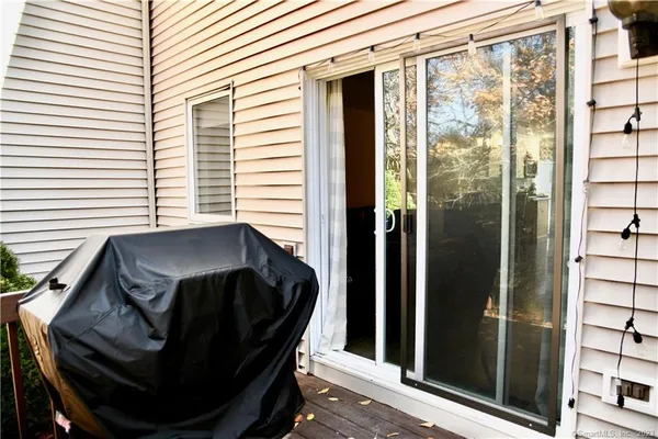 a view of a balcony with chair and door
