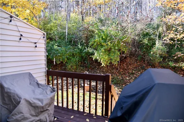 a view of a balcony with wooden fence and floor