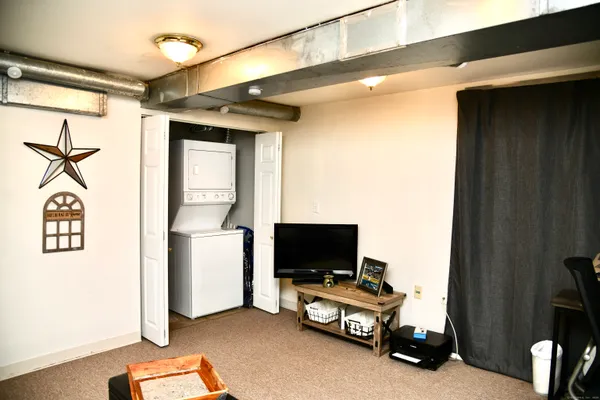 a view of a livingroom with furniture and a flat screen tv