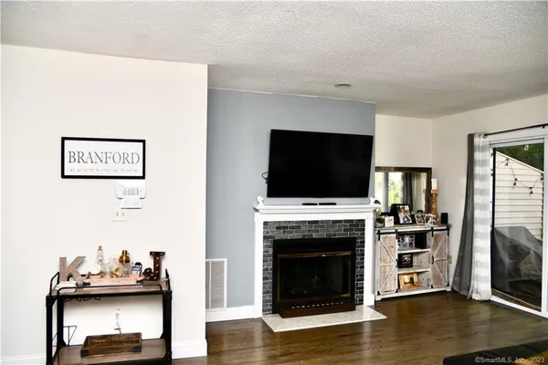 a living room with furniture a flat screen tv and a fireplace