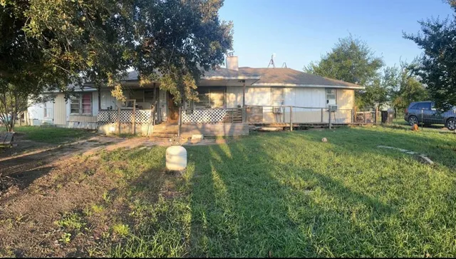 a front view of a house with a yard table and chairs