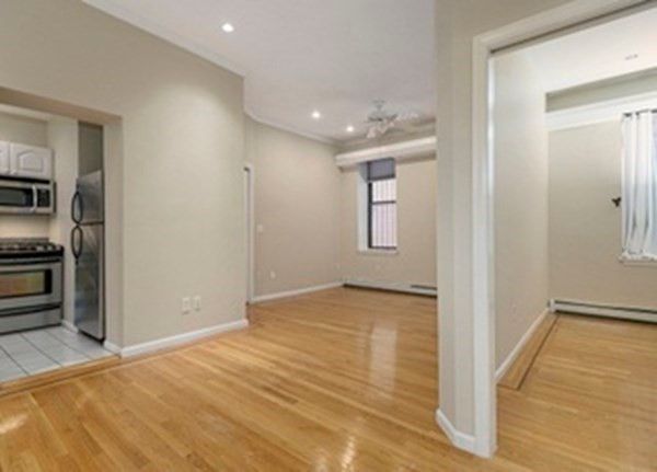 a view of a room with wooden floor and cabinet