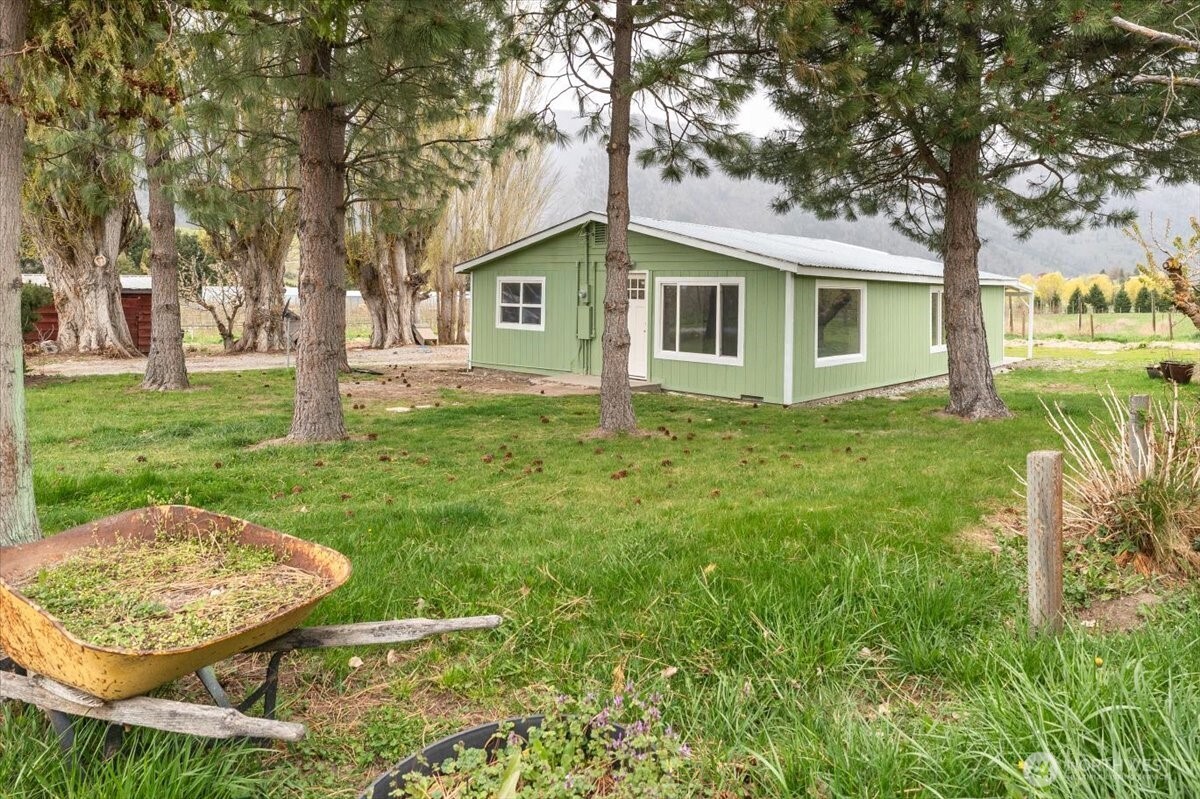293 Barkley Road Manson, WA 98831 - Photo 2 of 40 a backyard of a house with table and chairs