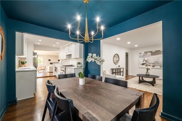 a large kitchen with a table and chairs
