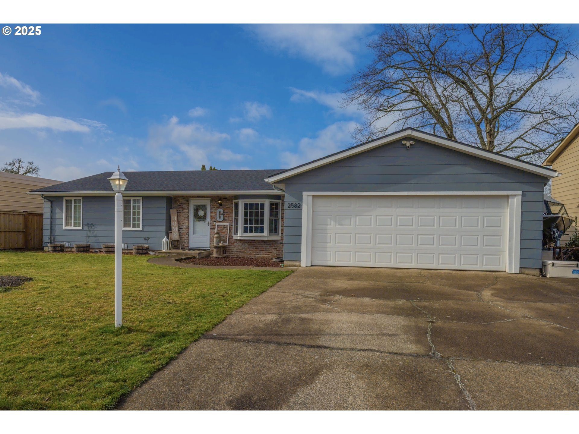 2582 20th Street Springfield, OR 97477 - Photo 1 of 16 a view of a yard in front of a house with a large tree