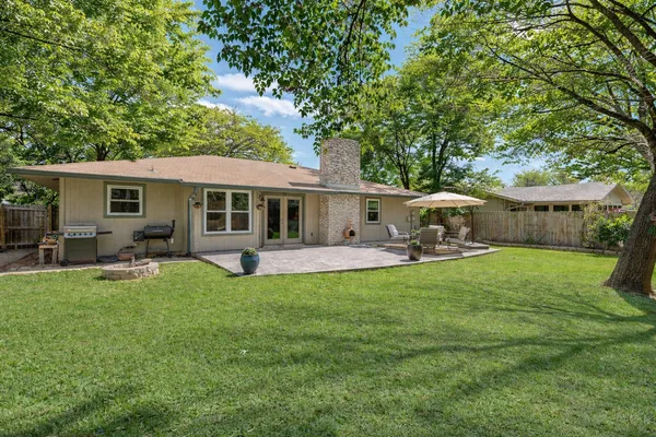 a view of a house with a backyard and a patio