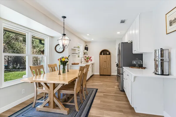 a view of a dining room with furniture window and wooden floor