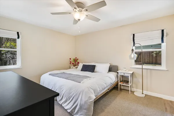 a bedroom with a bed and a window