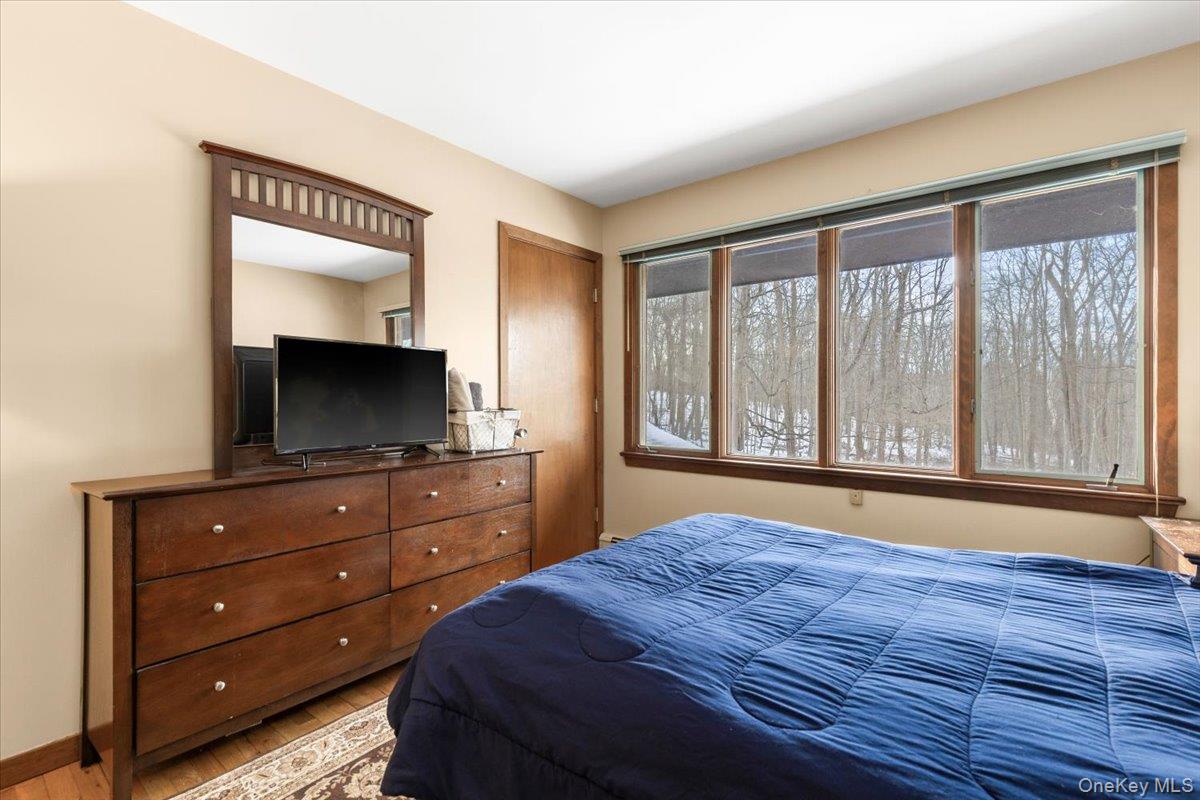 111 Philipse Brook Road Garrison, NY 10524 - Photo 11 of 21 Bedroom – with large windows overlooking wooded grounds.