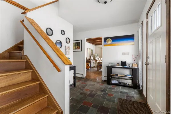 a view of front door with dining room and stairs