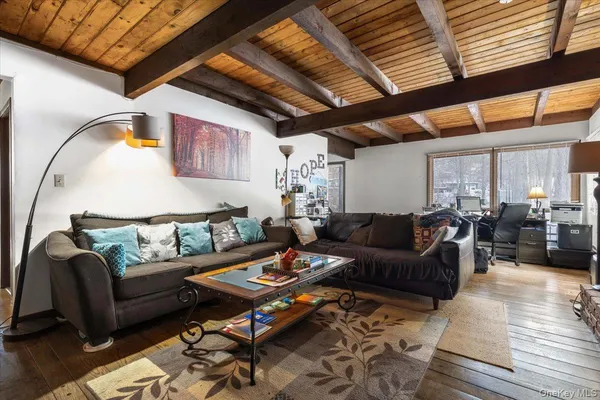a living room with furniture a rug and a chandelier