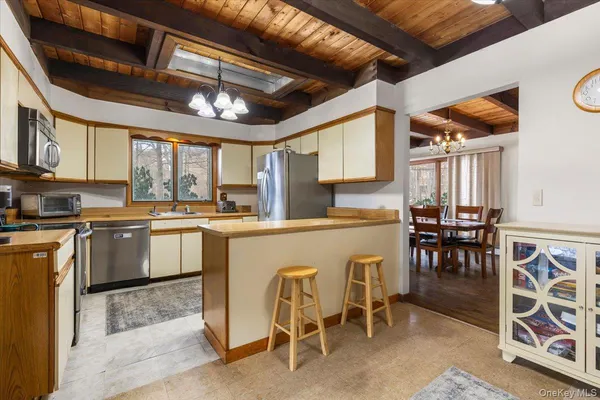 a kitchen with appliances cabinets and a counter top space