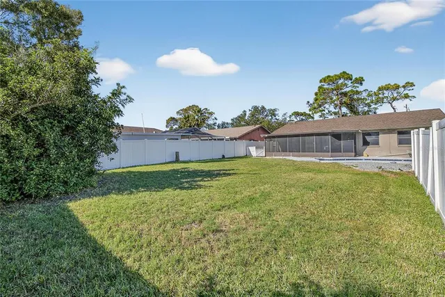 a view of a house with a backyard