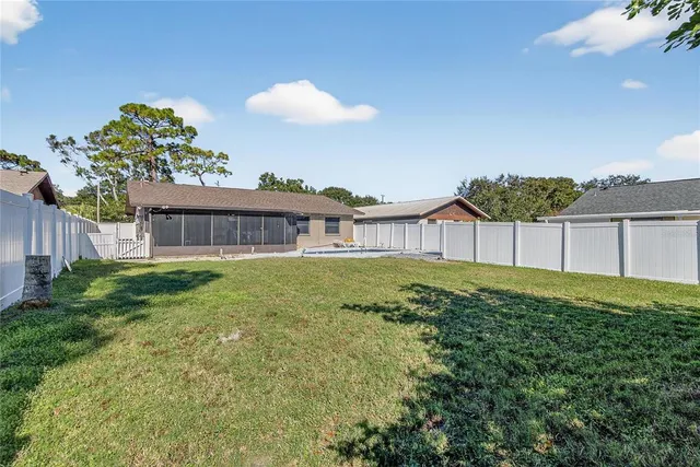 a view of a house with a patio and a garden