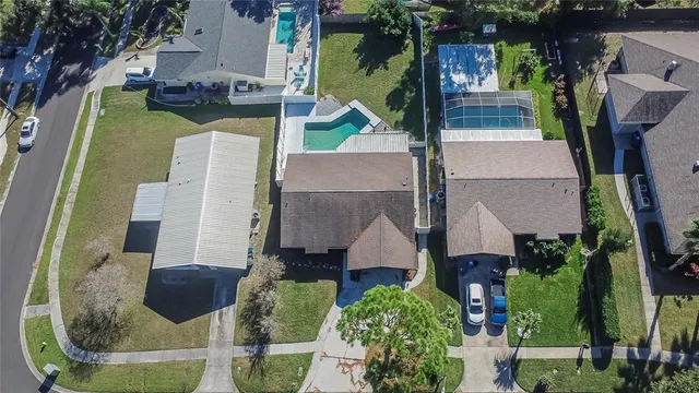 an aerial view of residential houses with city view and outdoor space