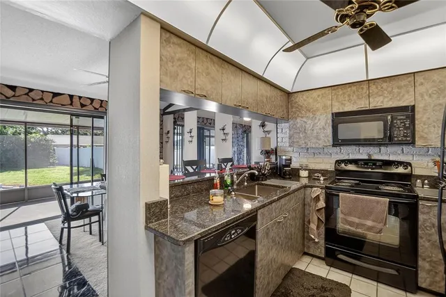a kitchen with a sink appliances and cabinets