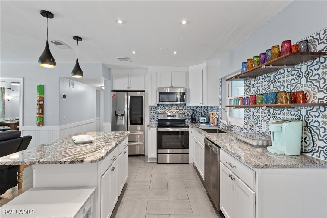 5216 Rutland Court Cape Coral, FL 33904 - Photo 21 of 47 a kitchen with a sink counter top space and stainless steel appliances