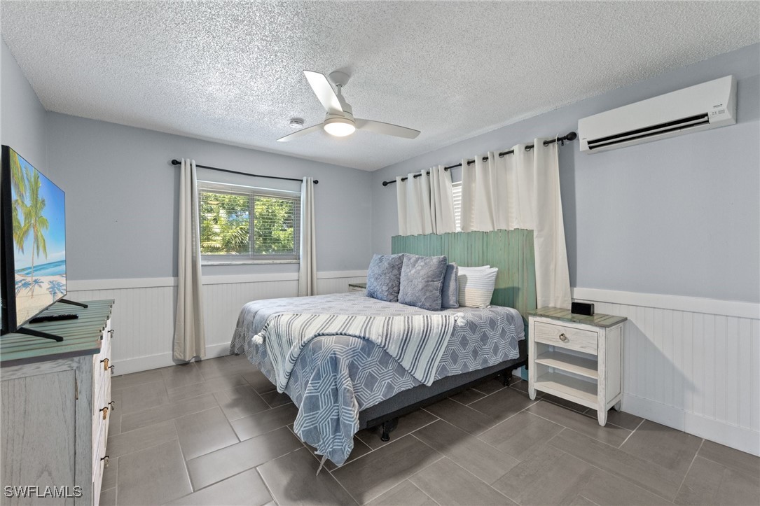 5216 Rutland Court Cape Coral, FL 33904 - Photo 24 of 47 a bedroom with a bed tv and a window