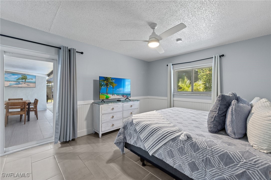 5216 Rutland Court Cape Coral, FL 33904 - Photo 3 of 47 a bedroom with a bed and a chandelier