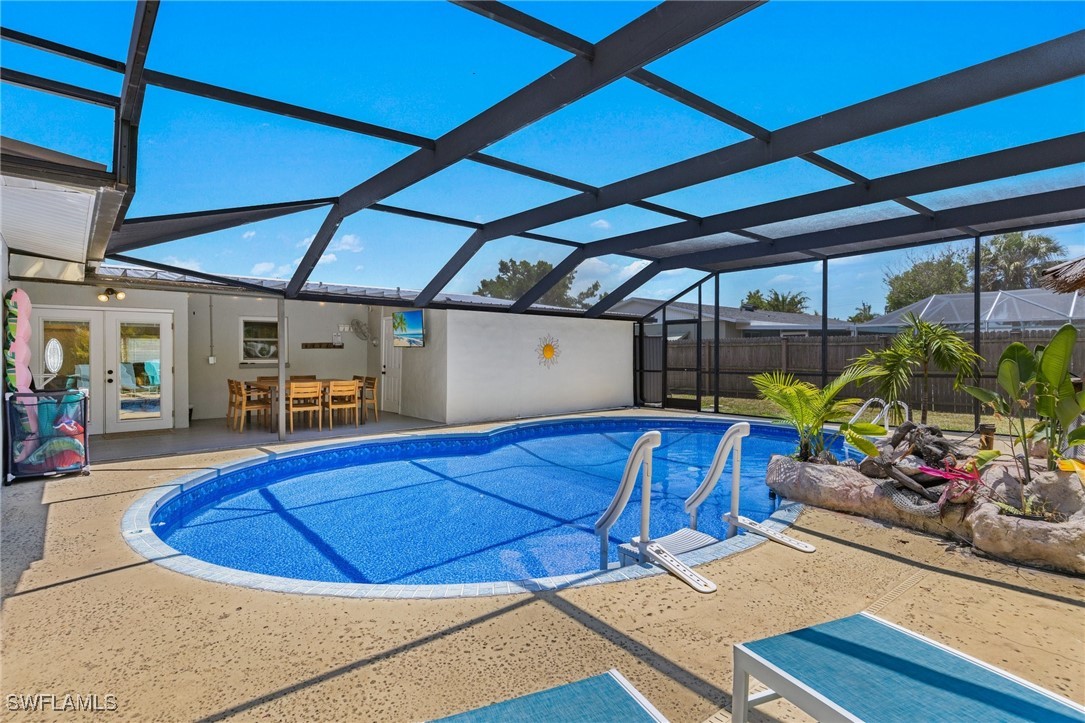 5216 Rutland Court Cape Coral, FL 33904 - Photo 34 of 47 a view of a patio with table and chairs potted plants