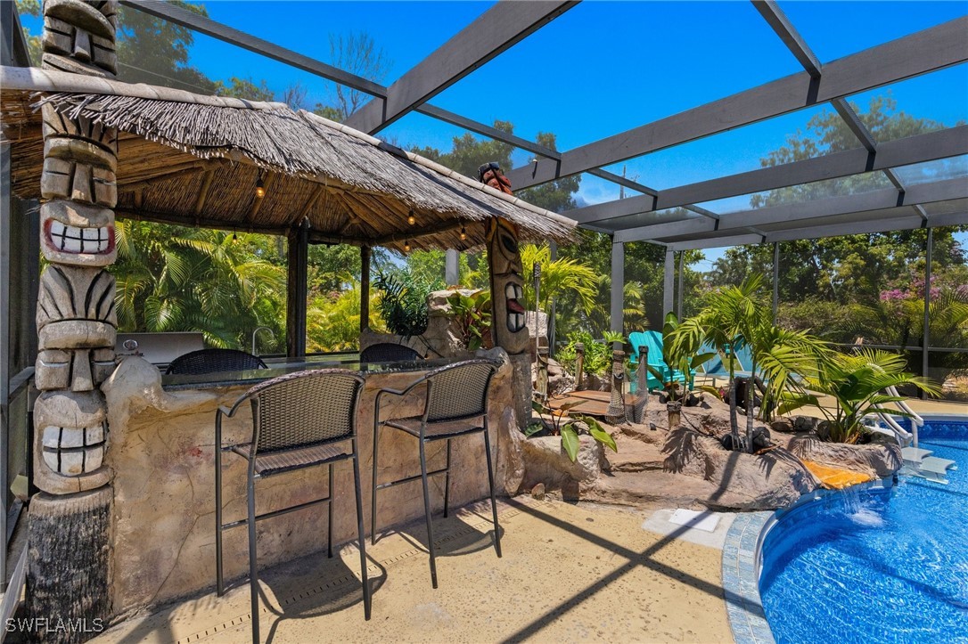 5216 Rutland Court Cape Coral, FL 33904 - Photo 39 of 47 a patio with glass top table and chairs