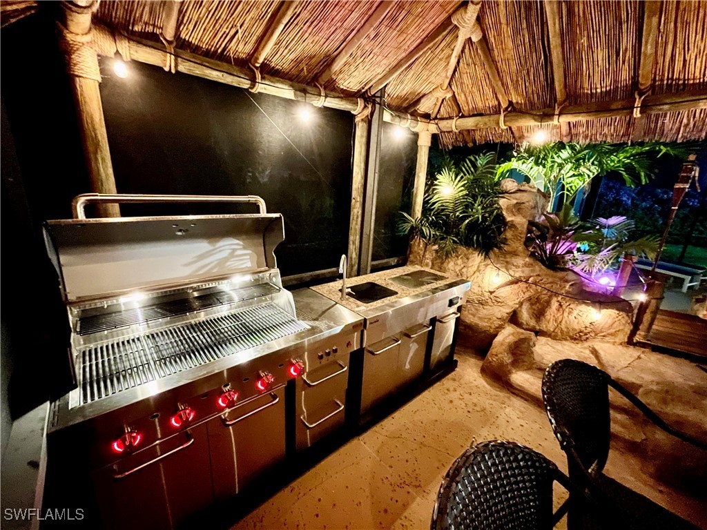 5216 Rutland Court Cape Coral, FL 33904 - Photo 6 of 47 a kitchen with stainless steel appliances granite countertop a stove a sink and a microwave