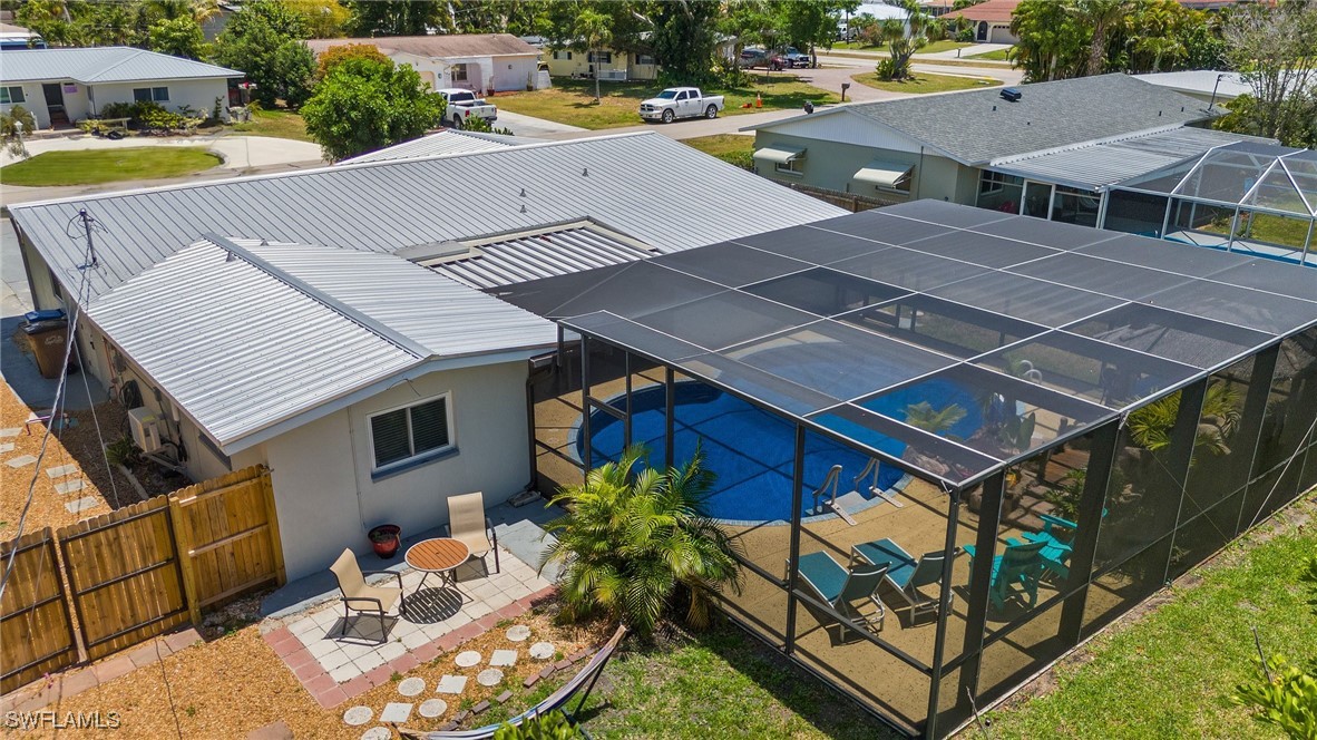 5216 Rutland Court Cape Coral, FL 33904 - Photo 10 of 47 an aerial view of a house with swimming pool and patio